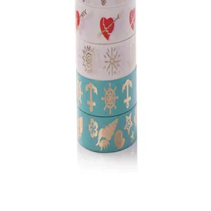 Gold foil washi tape detail shot showing decorative patterns like hearts, sun, and anchors.