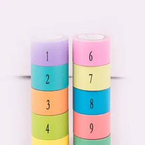 Close-up detail of colorful washi tape rolls stacked neatly with clear printed number designs.