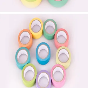 Detailed view of colorful solid washi tape rolls arranged for DIY journal decorating and crafts.