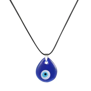 Detail view of a blue Turkish Evil Eye teardrop pendant on a black cord necklace