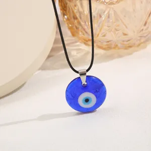 Detail shot of the Turkish Evil Eye pendant necklace featuring a deep blue glass finish