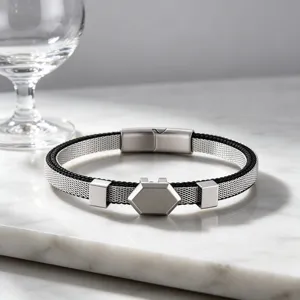 Close-up of stainless steel mesh bracelet with hexagonal plate and magnetic clasp for men.