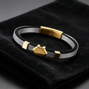 Close-up detail of the stainless steel mesh bracelet with hexagonal metal charm and magnetic clasp.