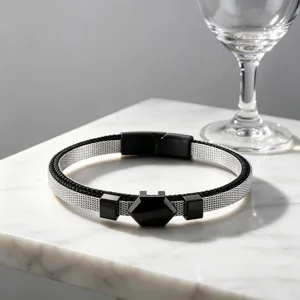 Detail shot of men's stainless steel mesh bracelet with a sleek hexagonal black accent plate.