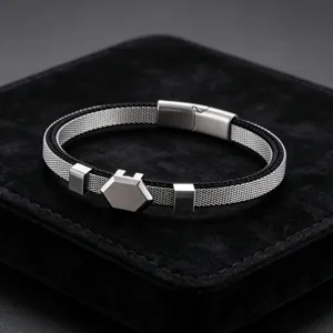 Men's stainless steel mesh bracelet detail showing hexagonal metal plaque and magnetic clasp.