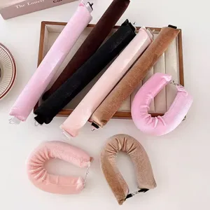 Macro shot of colorful velvet heatless hair rollers with hooks on a white desk