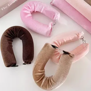 Macro detail view of heatless velvet hair curlers with hooks in various pastel colors