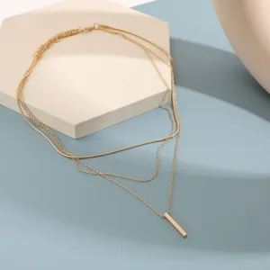 Élégant collier doré à trois rangs doté d'un pendentif barre verticale minimaliste