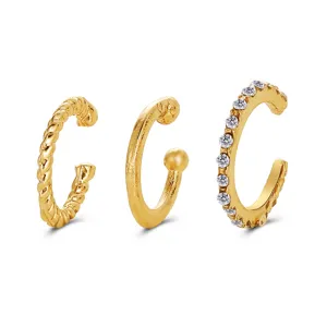 Set of three gold-plated C-shaped ear cuffs including textured and rhinestone designs.