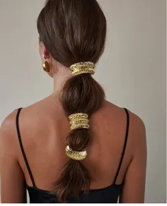 Elegant textured gold metal hair rings set for ponytail shown on model detail view