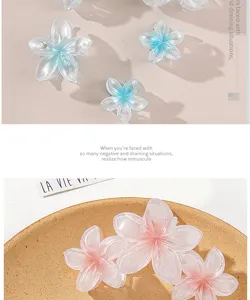 Close-up detail of gradient pink and blue mermaid flower hair clips with translucent finish