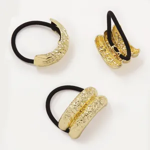 Set of three elegant gold metallic textured hair ties with durable black elastic bands