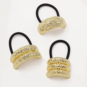 Set of three gold textured metal elastic hair ties with a hammered geometric finish