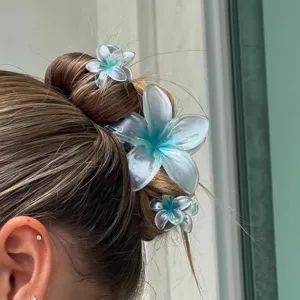 Gradient blue translucent plumeria hair claw clips set shown on a hair bun for summer