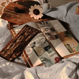 Vintage journal material paper pack with retro newspaper designs for DIY scrapbooking and collage.