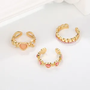 Close-up of three-piece heart and thorn ring set with pink faux cat's eye stones