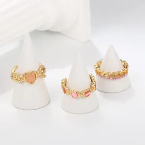 Detailed macro view of a 3-piece gold ring set with pink heart and cat's eye stones