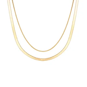 Detailed view of a double-layered gold snake chain necklace with high-shine metallic finish