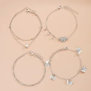 Vista detallada del conjunto de tobilleras de mariposa y corazón plateadas, set de 4 piezas
