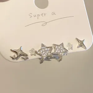 Élégantes boucles d'oreilles étoiles argentées avec oxydes de zirconium sur carte