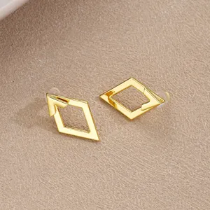 Close-up of gold geometric hollow diamond earrings with minimalist creative design.