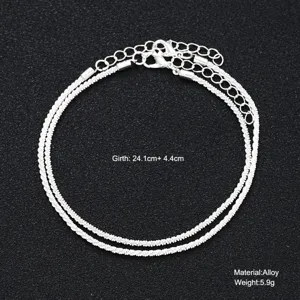 Close-up detail of sparkling silver alloy double-layer anklet showing size and weight