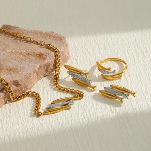 Detail view of 18K gold plated stainless steel fish jewelry set with crystal accents