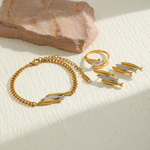 Detail view of a three fish motif jewelry set including bracelet, ring and earrings