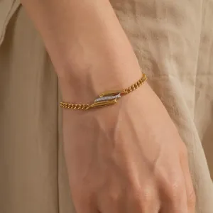 Detailed view of two-tone titanium steel bracelet featuring triple fish design.