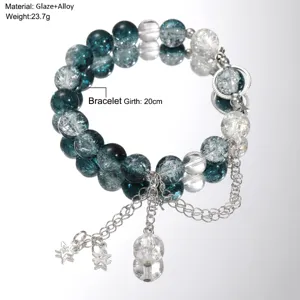Macro detail of translucent blue and clear glaze beads on a silver alloy bracelet