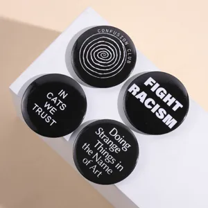 Minimalist round black tinplate pins set with English slogans and artistic patterns
