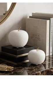 Modern minimalist white ceramic apple decor with gold stem for home office desk.