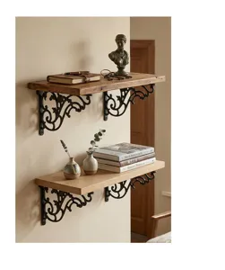 Close-up of vintage ornate cast iron shelf brackets supporting wooden wall shelves