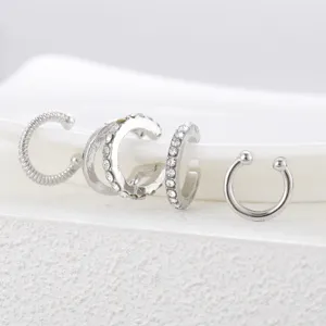 Close-up detail of a 4-piece set of silver C-shaped non-piercing ear cuffs for women
