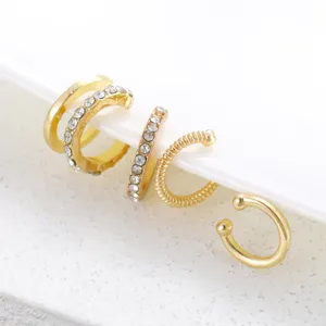 Detail of 5 pieces gold non-pierced ear cuff set with rhinestones and textured bands.
