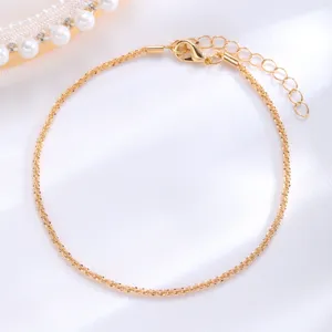 Macro view of a sparkling gold anklet featuring a textured surface and lobster clasp.