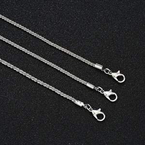 Detail view of sparkling silver anklet chains with sturdy lobster clasps.