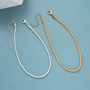 Detailed view of sparkly textured gold and silver anklet set with extender chains.