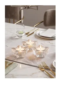 Romantische kristallen ster-vormige kandelaars op een gedecoreerde marmeren eettafel