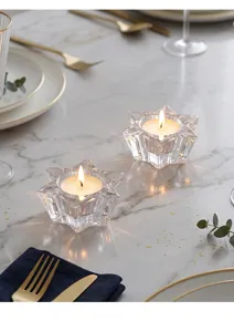 Detailopname van stervormige kristallen glazen kandelaars voor een romantische tafelsfeer