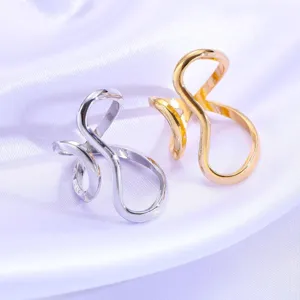 Close-up of minimalist irregular wavy line open rings in gold and silver finishes