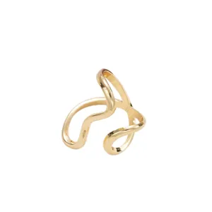 Close-up of a gold-toned irregular wavy line open ring with polished finish.
