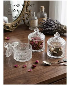 Close-up of vintage relief glass jars with decorative lids on a wooden vanity