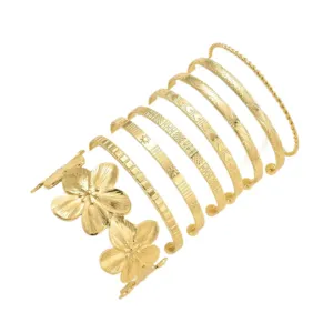 Elegant set of 8 gold-colored bangles with floral and geometric textured patterns