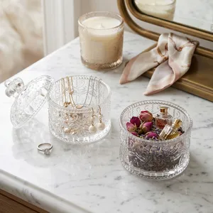 Vintage embossed glass jewelry box with crown lid on marble surface