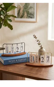 Gros plan de calendriers perpétuels vintage en fer sur un bureau avec décoration intérieure.