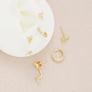 Detailed macro view of copper-plated gold earrings set with sparkling zircon stones
