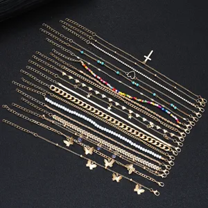 A comprehensive 22-piece gold anklet set with cross, butterfly charms, and beads