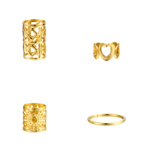 Detail showing golden hollow heart and geometric DIY hair braid rings and cuffs.