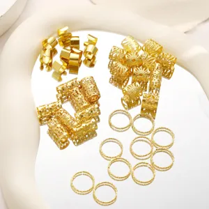 Macro detail of 40pcs gold metal hollow braid hair jewelry accessories on a mirror tray